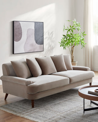  Luxurious Cila Sofa in soft blush pink fabric, featuring tufted backrest and stylish tapered legs